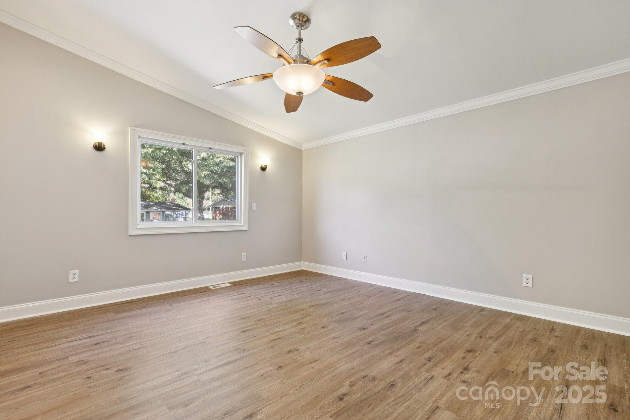 1024 Old Mountain View Road Mount Holly, NC 28120 - Photo 35 of 41 an empty room with wooden floor and ceiling fan