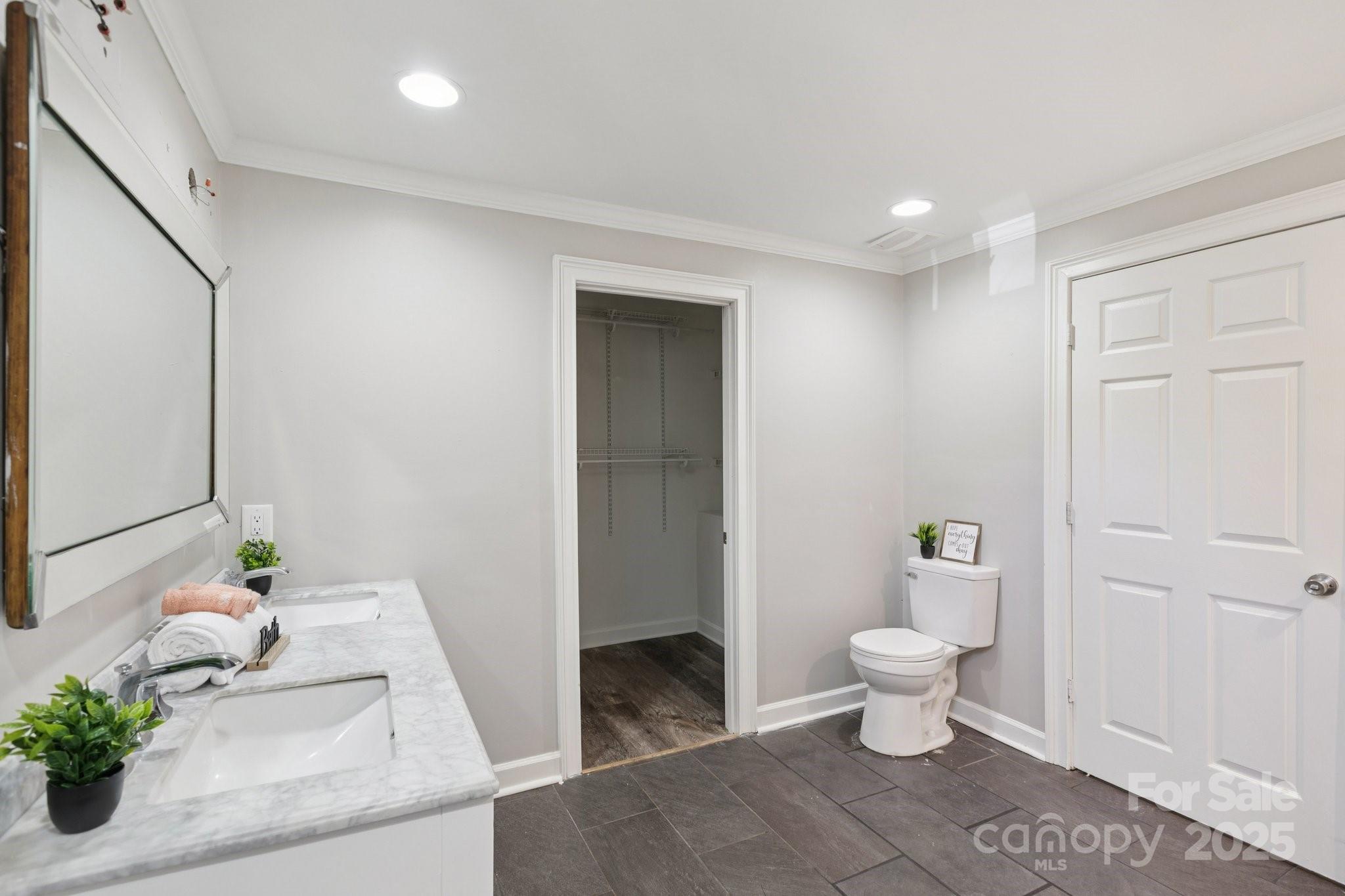 1024 Old Mountain View Road Mount Holly, NC 28120 - Photo 38 of 41 a bathroom with a sink a toilet and a mirror