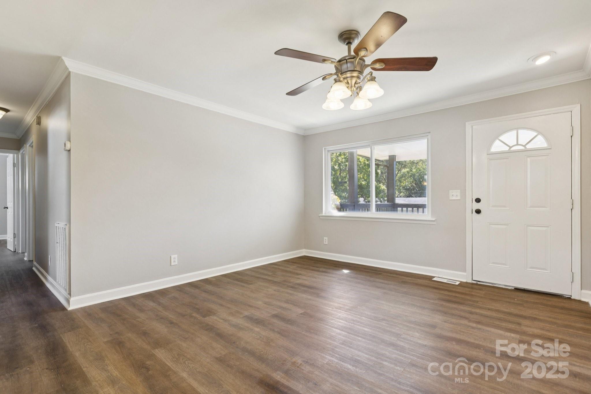 1024 Old Mountain View Road Mount Holly, NC 28120 - Photo 41 of 41 an empty room with wooden floor chandelier fan and windows