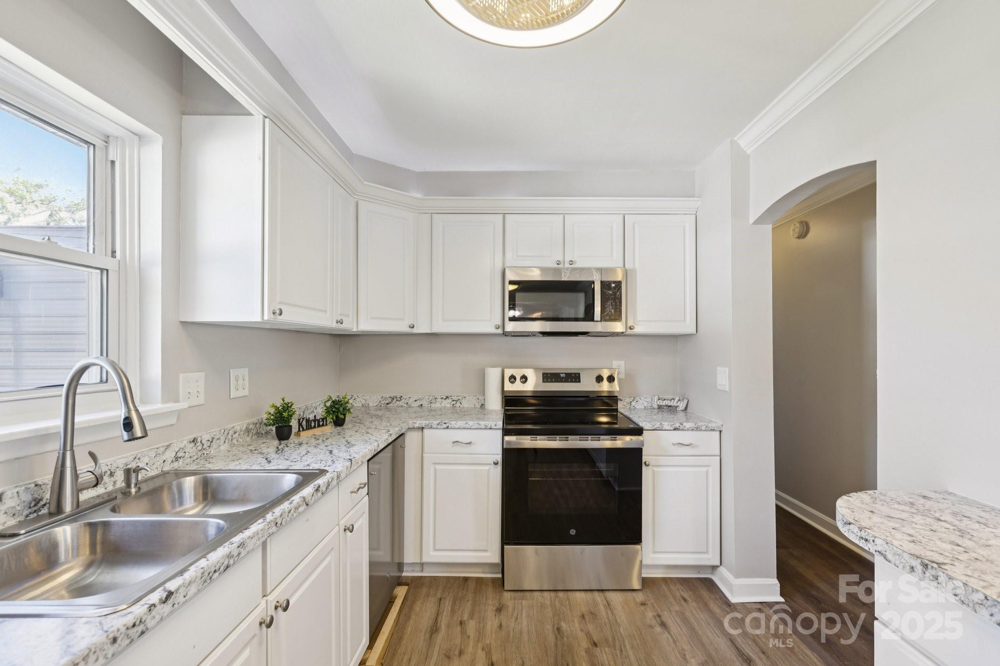1024 Old Mountain View Road Mount Holly, NC 28120 - Photo 10 of 41 a kitchen with stainless steel appliances granite countertop a sink stove and refrigerator