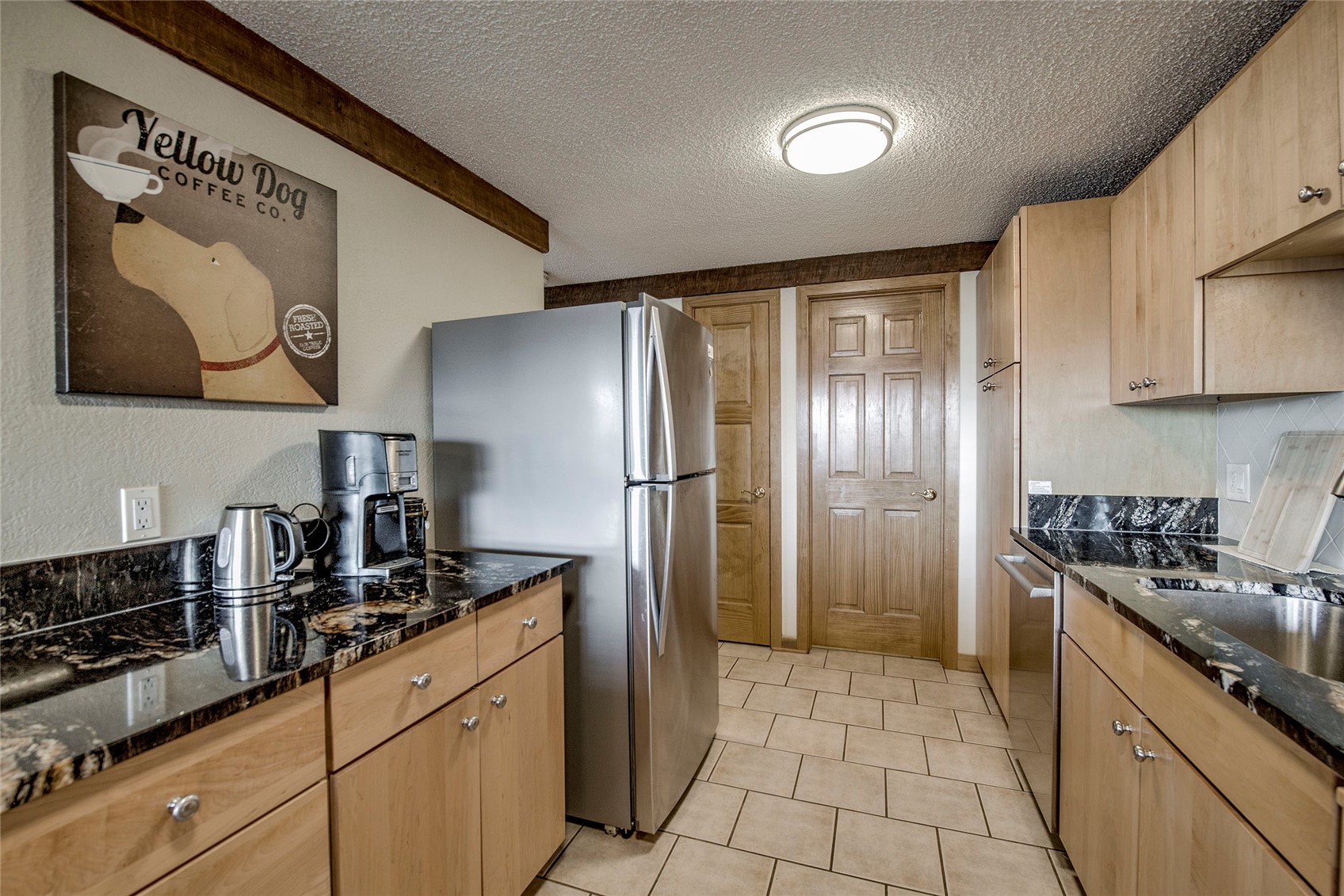 187 Fuller Placer Road, Unit B Breckenridge, CO 80424 - Photo 10 of 33 a kitchen with stainless steel appliances granite countertop a refrigerator and a stove top oven