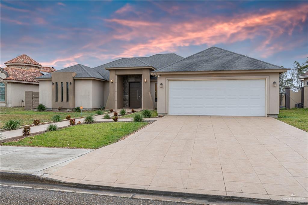 721 Mia Rose Lane Alamo, TX 78516 - Photo 1 of 1 View of front facade featuring a lawn and a garage