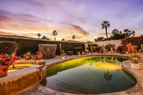 a view of a swimming pool with a lawn chairs