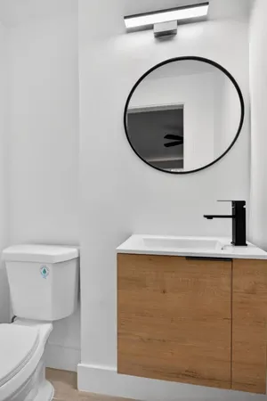 a bathroom with a toilet and a mirror