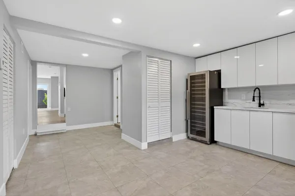 a view of an empty room with a kitchen