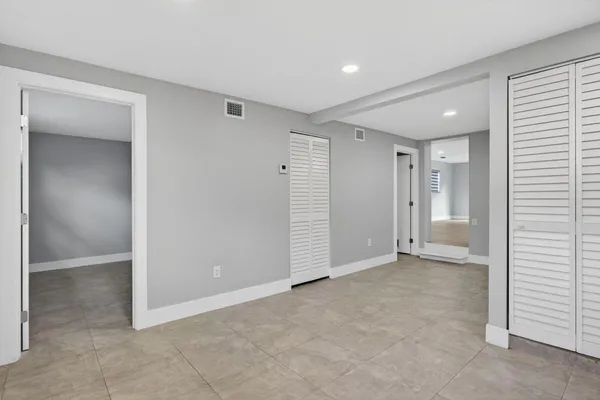 a view of an empty room and closet area