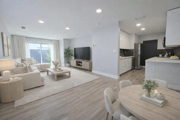 a living room with furniture flat screen tv and couches