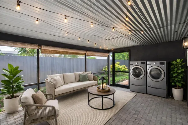 a living room with furniture a rug and white walls