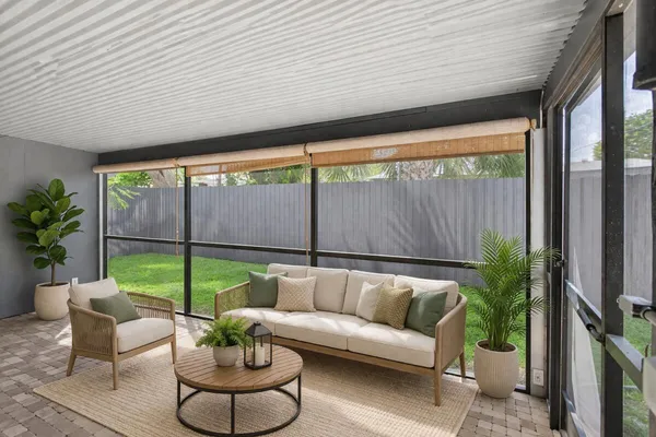 a balcony with furniture and a potted plant