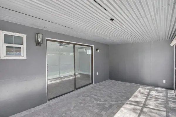 a bedroom with a bed and glass door