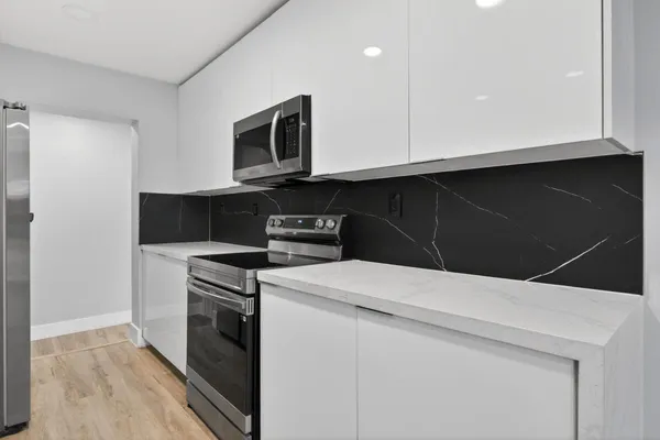 a kitchen with a stove and a microwave