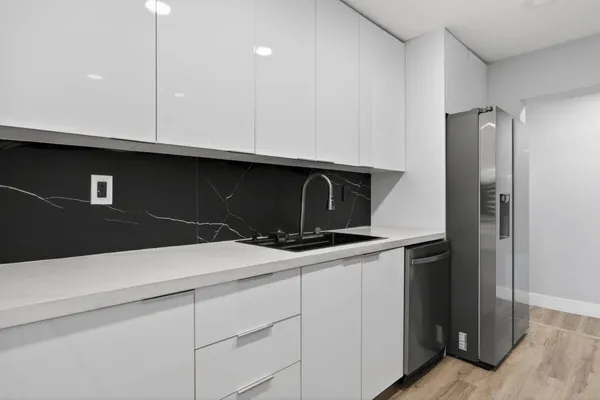 a kitchen with a sink and refrigerator