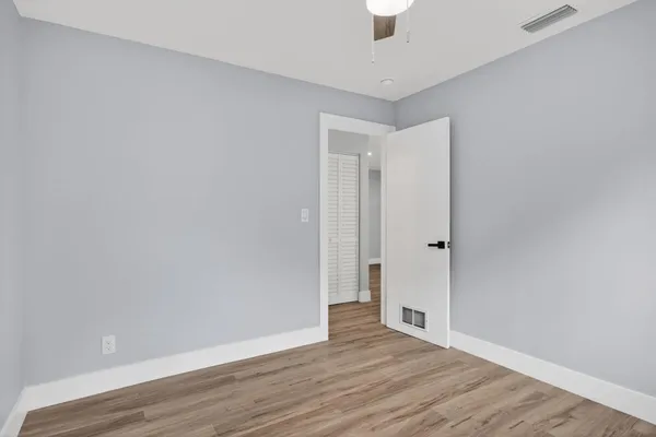 a view of an empty room and wooden floor