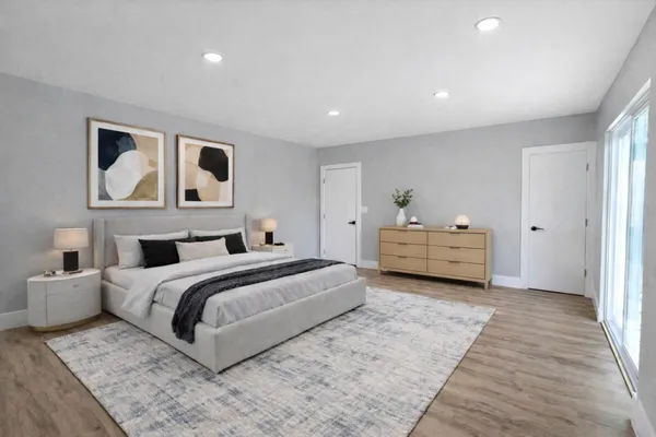 a spacious bedroom with a bed and a couch