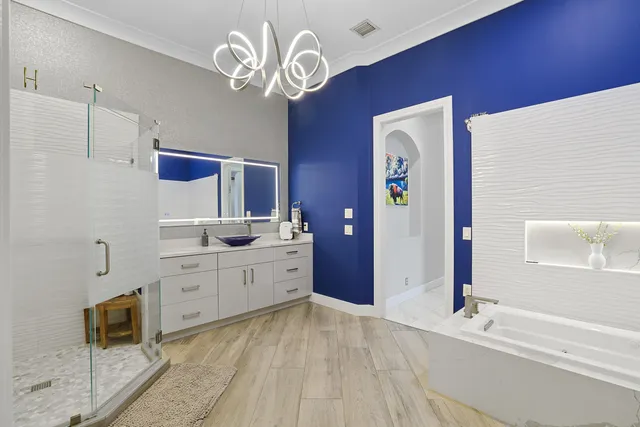 a spacious bathroom with a sink a mirror and a shower