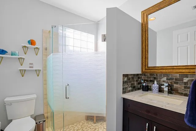 a bathroom with a sink a toilet and a mirror