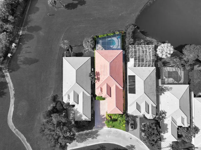 an aerial view of multiple houses with a yard