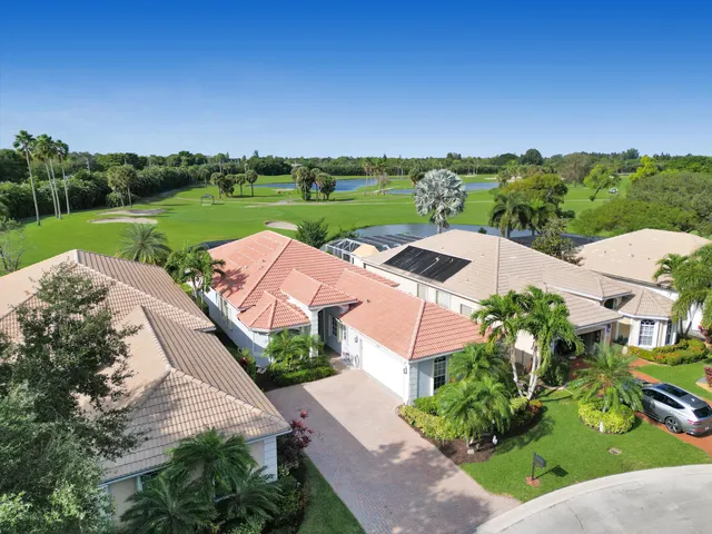 an aerial view of a house with garden space and street view