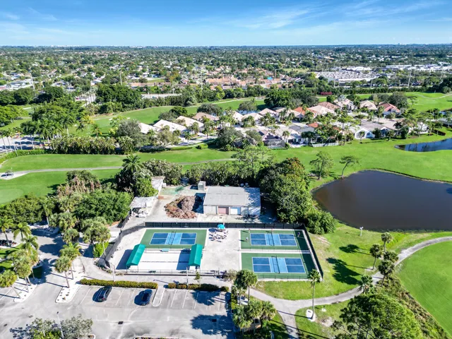 an aerial view of residential houses with outdoor space and seating