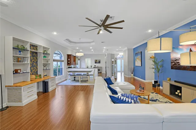a living room with stainless steel appliances kitchen island granite countertop furniture and a kitchen view