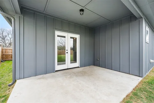 a view of a big room with wooden floor and windows