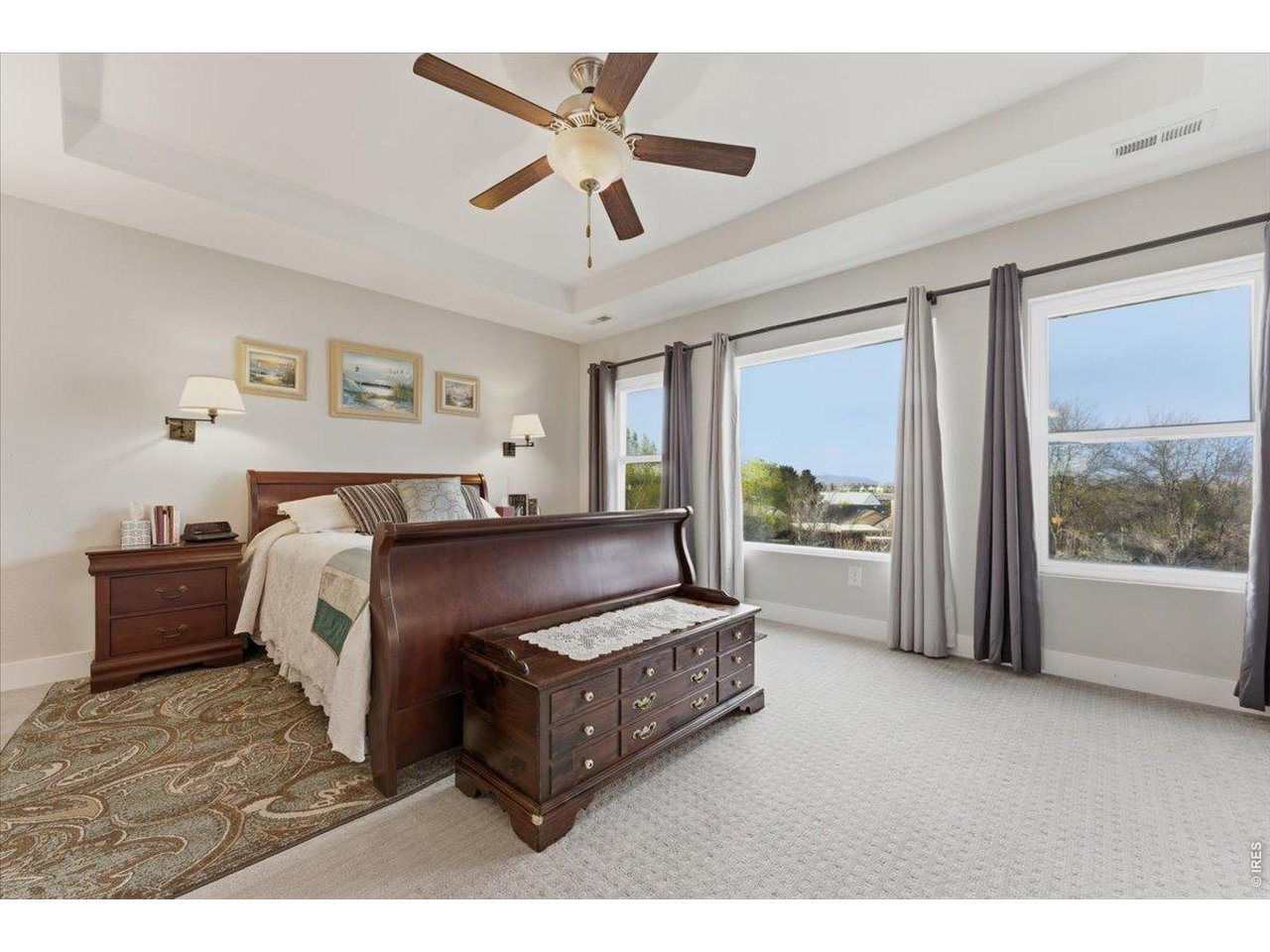 1148 Wagon Bend Road Berthoud, CO 80513 - Photo 29 of 50 a spacious bedroom with a bed and a large window