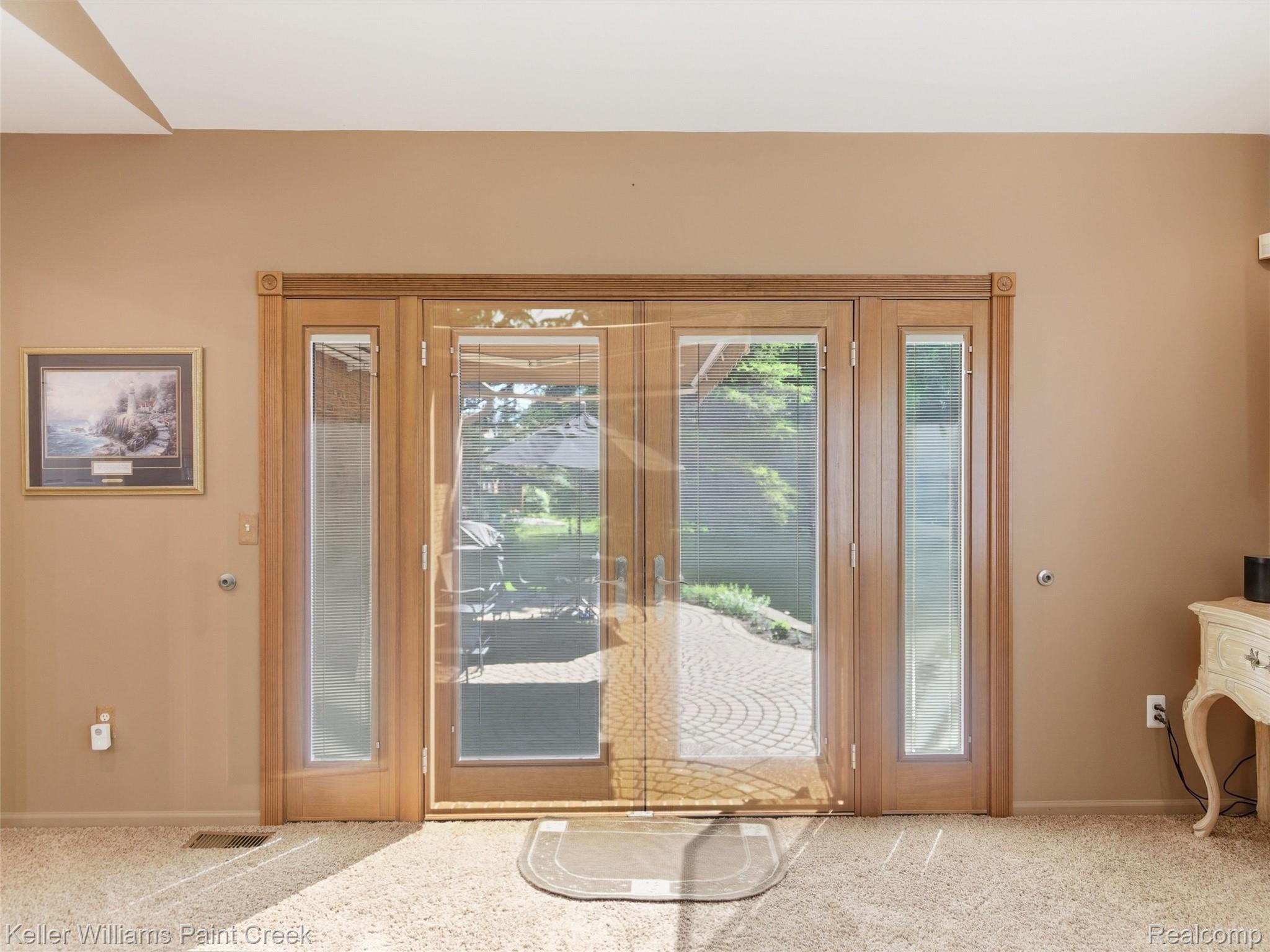 2842 Manorwood Road Troy, MI 48085 - Photo 61 of 72 French doors with sidelights opening to an outdoor patio with paver flooring