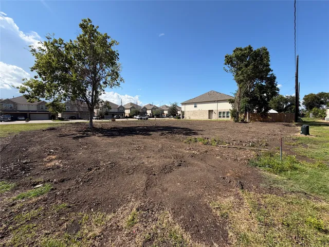 a front view of house with yard and trees