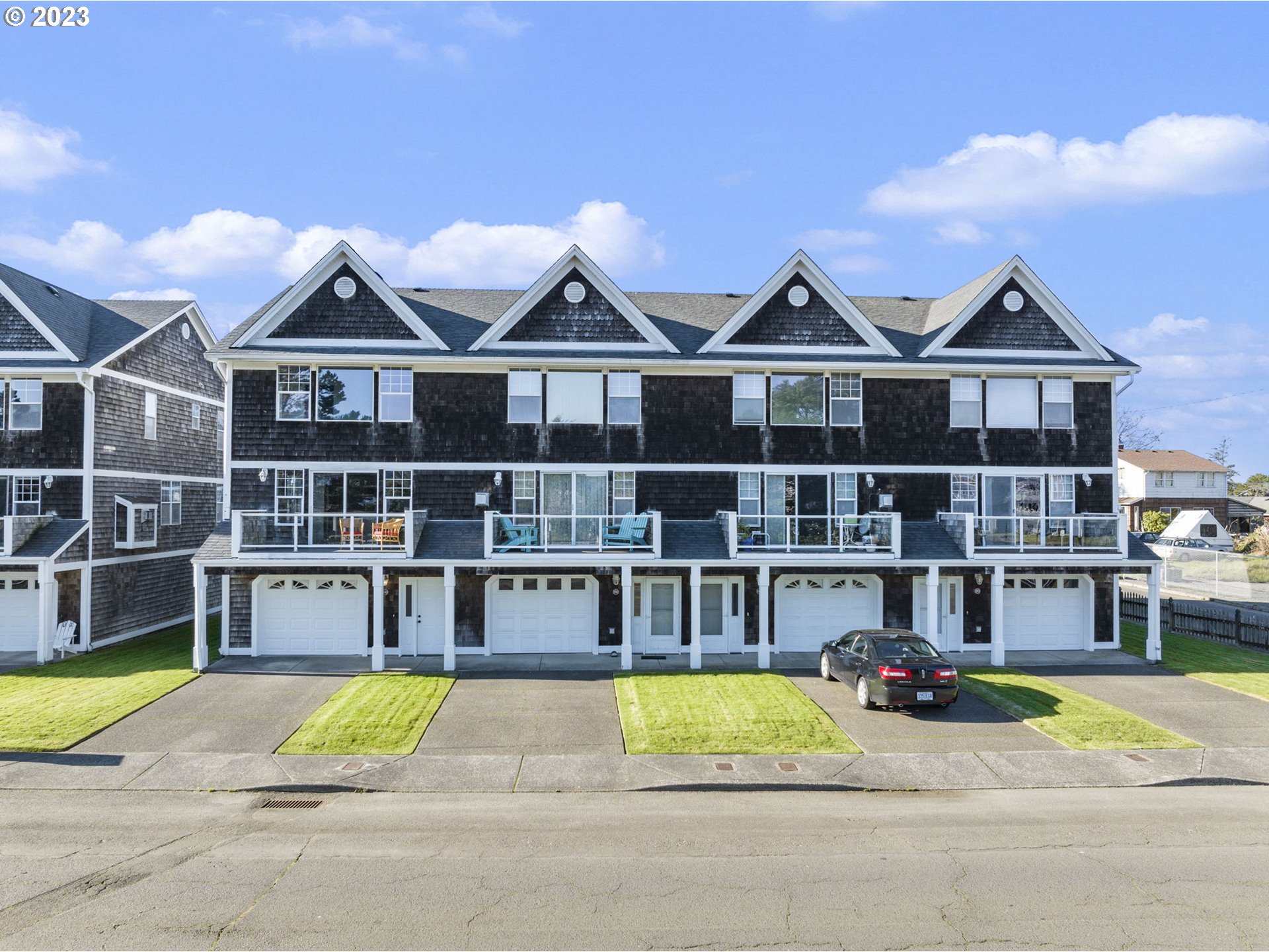 940 Necanicum Drive Seaside, OR 97138 - Photo 2 of 23 a view of houses with a swimming pool and a yard