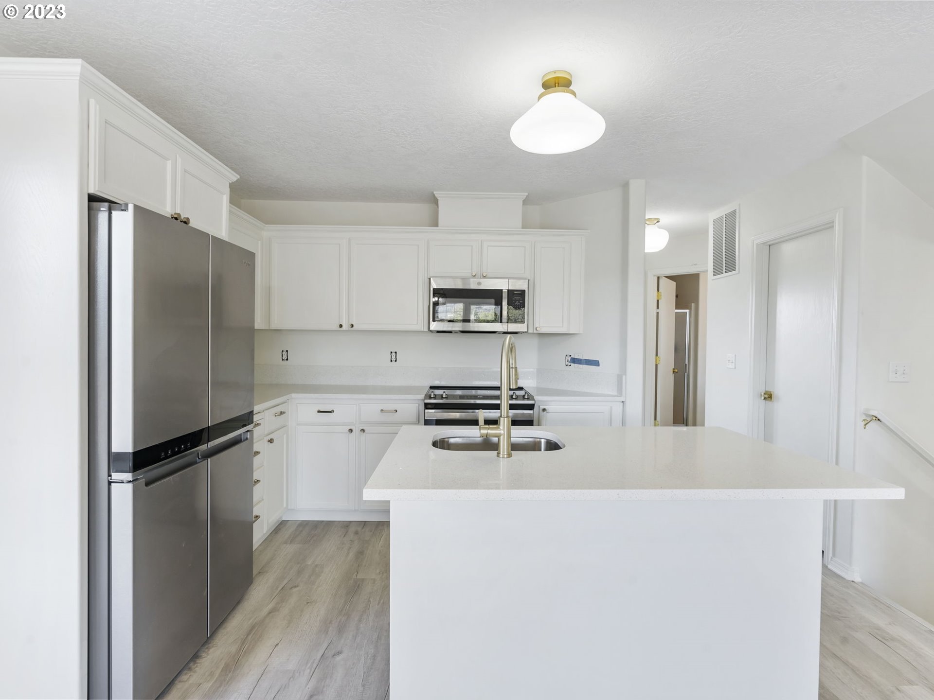 940 Necanicum Drive Seaside, OR 97138 - Photo 4 of 23 a kitchen with stainless steel appliances granite countertop a refrigerator a stove a sink and a granite counter tops