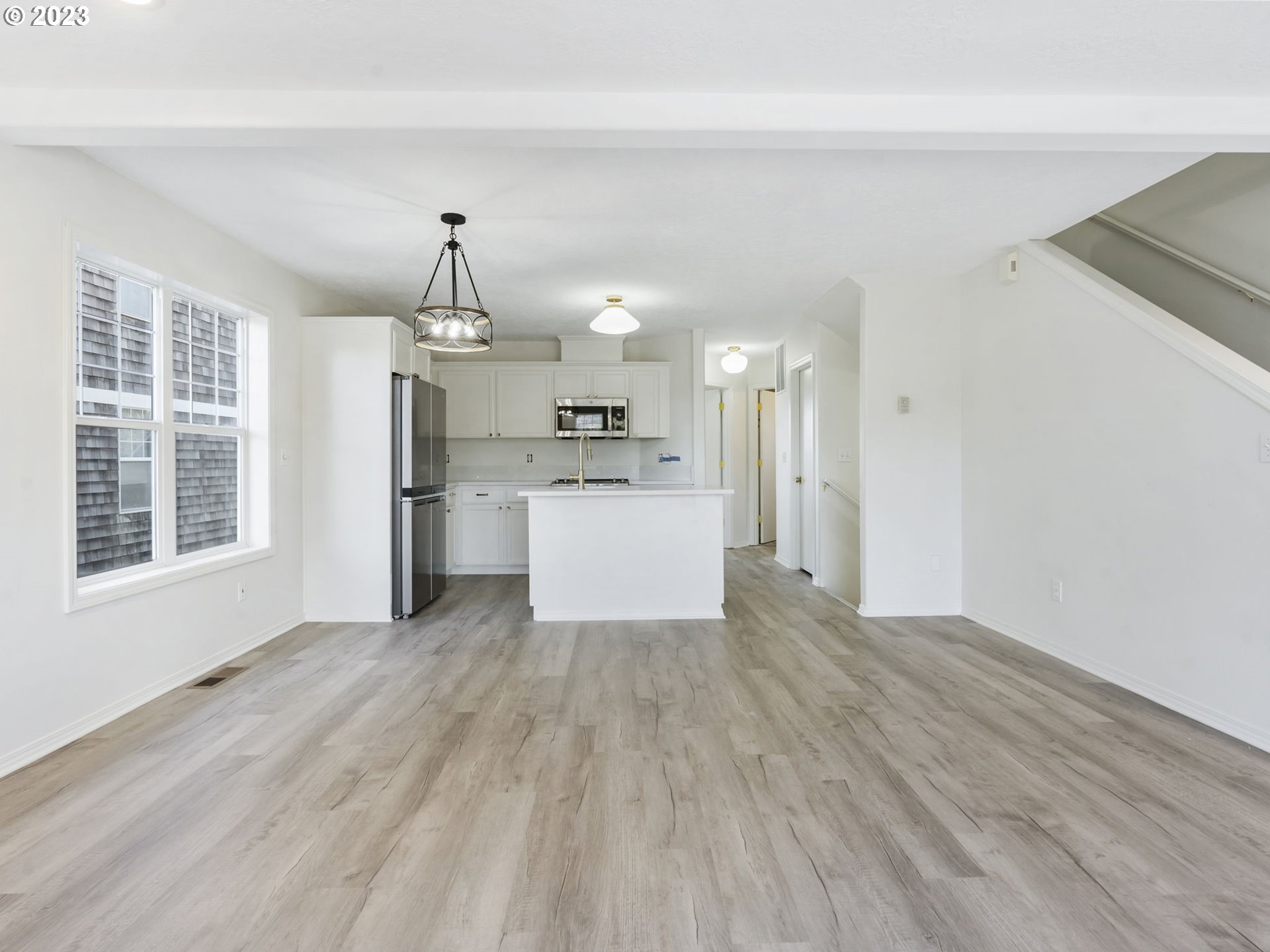 940 Necanicum Drive Seaside, OR 97138 - Photo 6 of 23 a large kitchen with cabinets wooden floor and stainless steel appliances