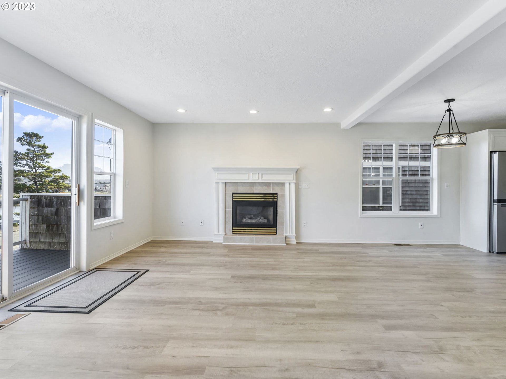 940 Necanicum Drive Seaside, OR 97138 - Photo 7 of 23 a view of an empty room with wooden floor and a window