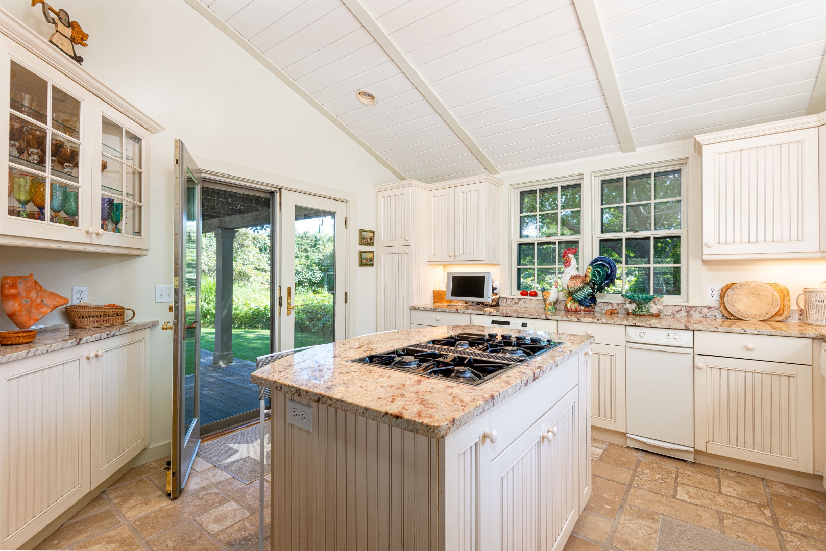26 Pocomo Road Nantucket, MA 02554 - Photo 11 of 43 a kitchen with a stove a sink a refrigerator and wooden cabinets
