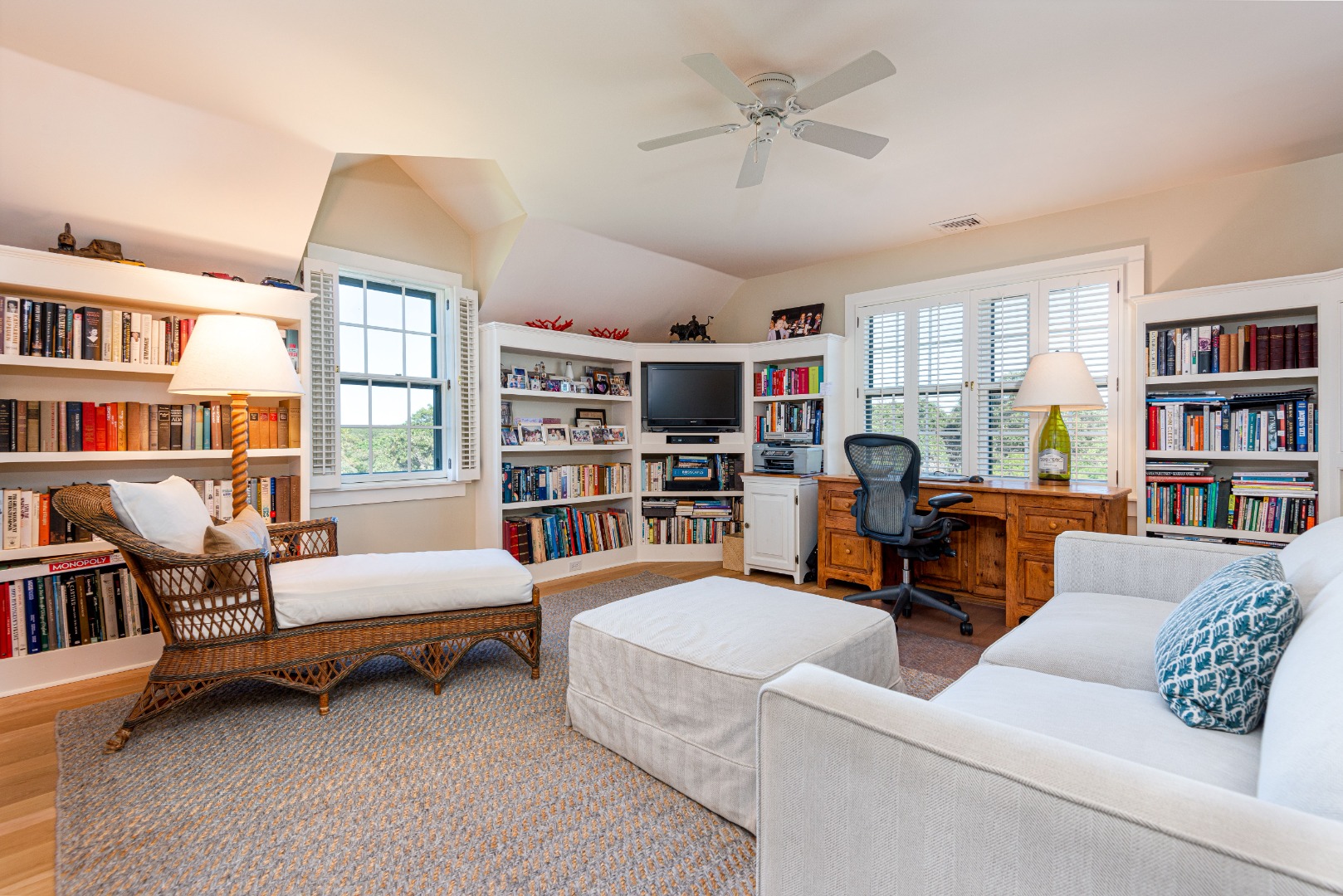 26 Pocomo Road Nantucket, MA 02554 - Photo 19 of 43 a living room with furniture and a book shelf