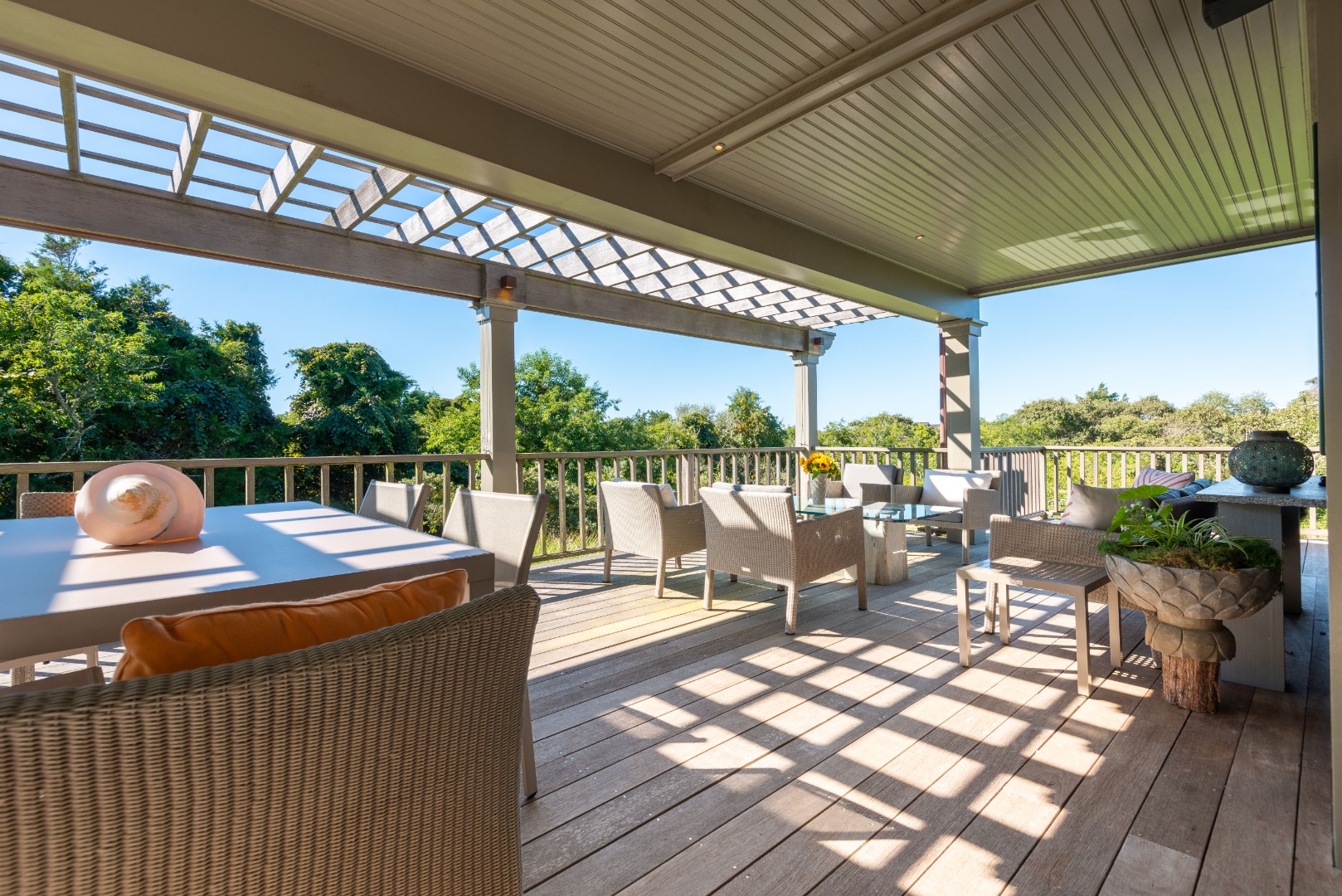 26 Pocomo Road Nantucket, MA 02554 - Photo 29 of 43 a view of a patio with a dining table and chairs with wooden floor