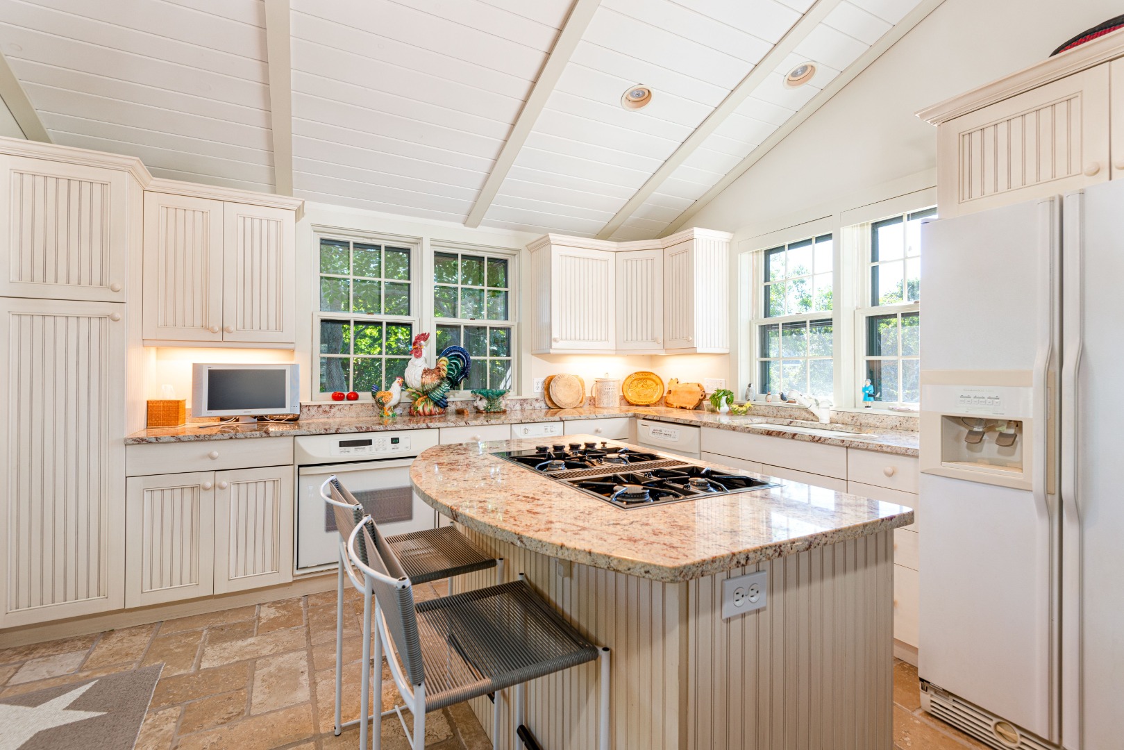 26 Pocomo Road Nantucket, MA 02554 - Photo 10 of 43 a kitchen with stainless steel appliances granite countertop a stove a refrigerator and a stove