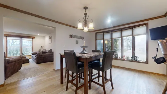 a view of a dining room with furniture large windows and wooden floor