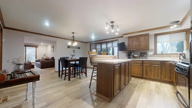 a kitchen with lots of counter top space and dining table