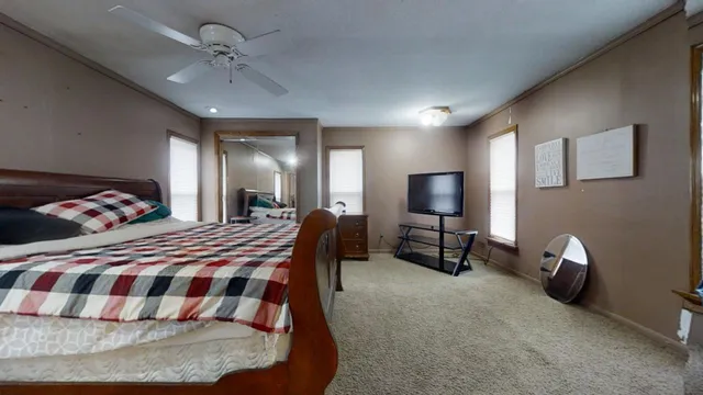 a bedroom with furniture and a mirror
