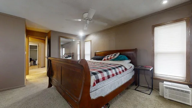 a bedroom with a bed and a chandelier