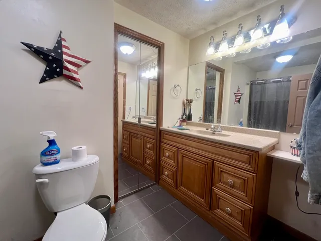 a bathroom with a toilet sink and mirror