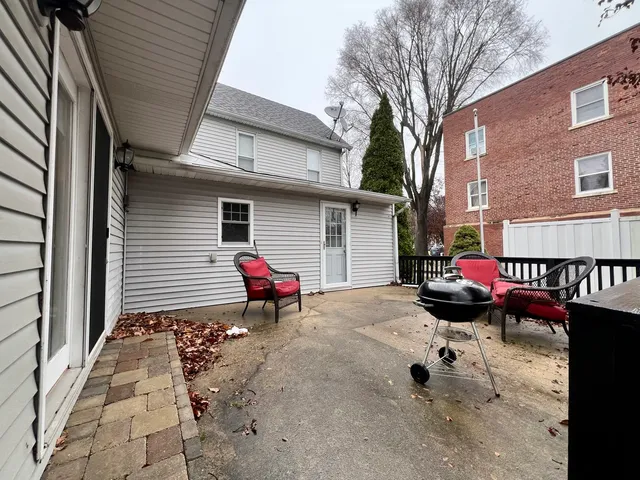 a view of a lounge chairs in the back yard of the house