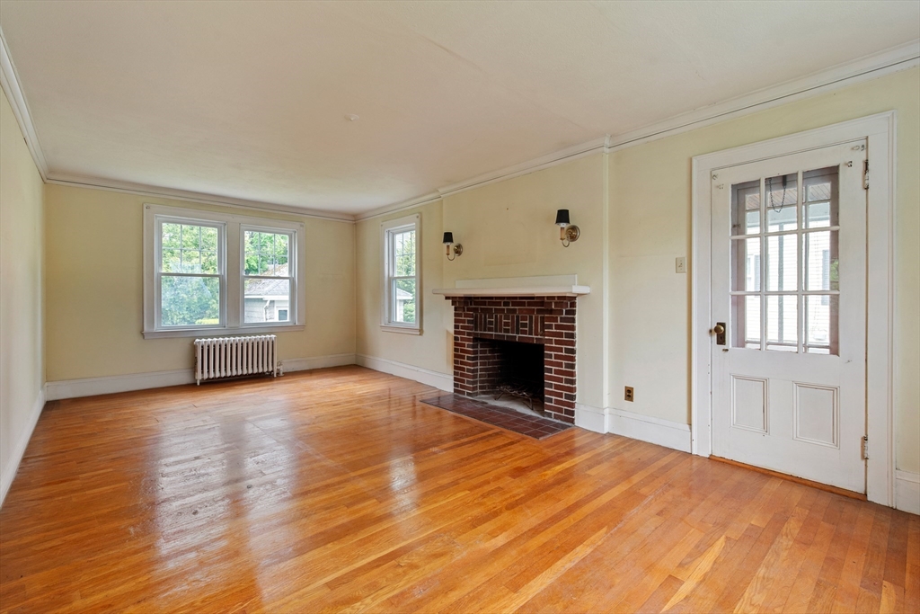 38 Bailey Road Arlington, MA 02476 - Photo 4 of 30 a view of empty room with wooden floor and fireplace