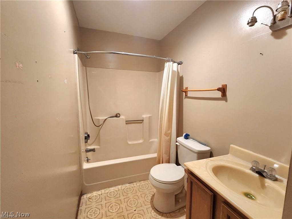 10345 Marne Road Frazeysburg, OH 43822 - Photo 38 of 50 Full bathroom featuring tile floors, vanity, toilet, and shower / tub combo with curtain