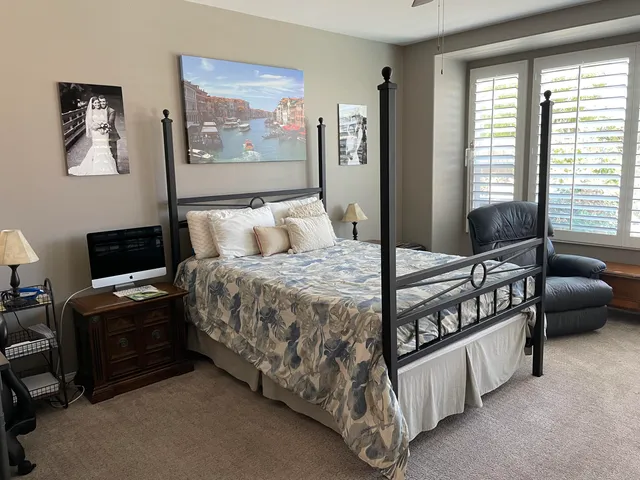 a bedroom with a bed a couch and a window