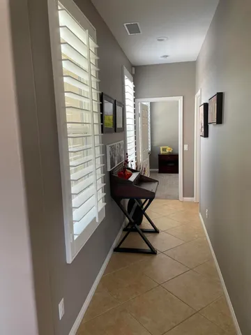 a living room with furniture a window and a flat screen tv