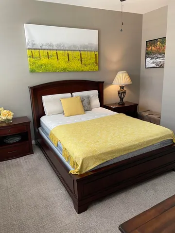 a bedroom with a bed and wall painting