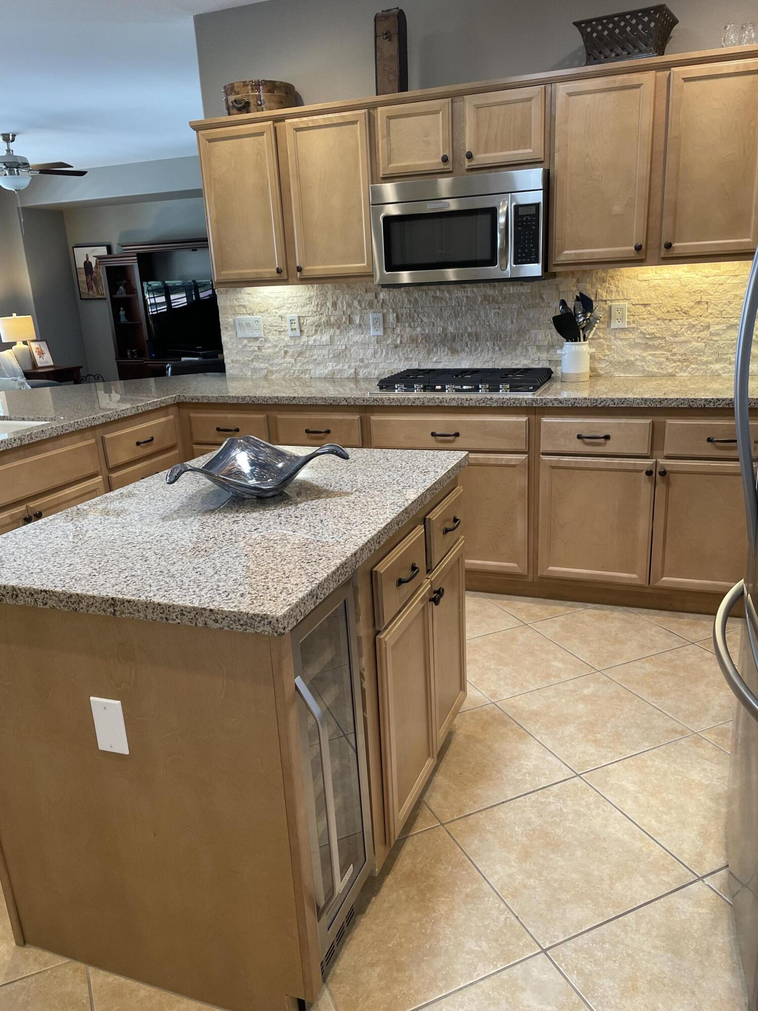 60880 Azul Court La Quinta, CA 92253 - Photo 10 of 33 a kitchen with stainless steel appliances granite countertop a sink stove and cabinets