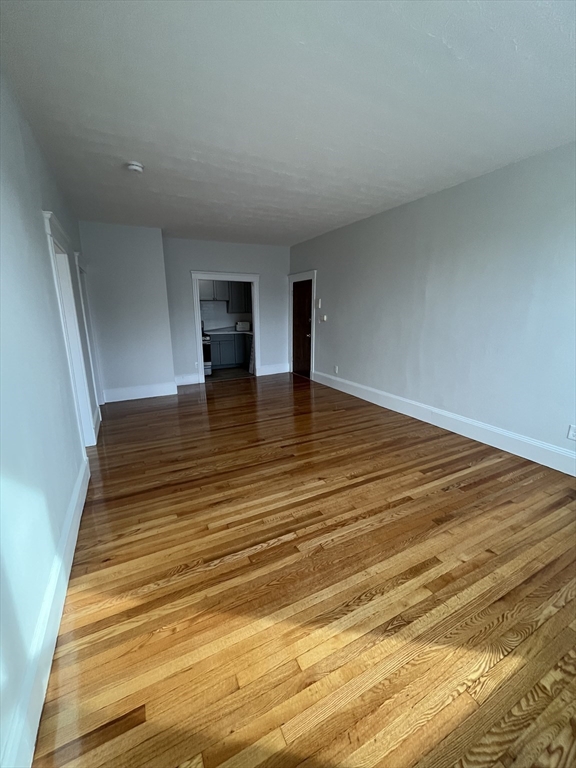 108 Bristol Road, Unit 1 Somerville, MA 02144 - Photo 10 of 24 a view of empty room with wooden floor