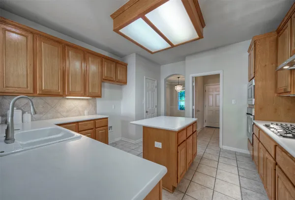 a kitchen that has a sink and a stove in it